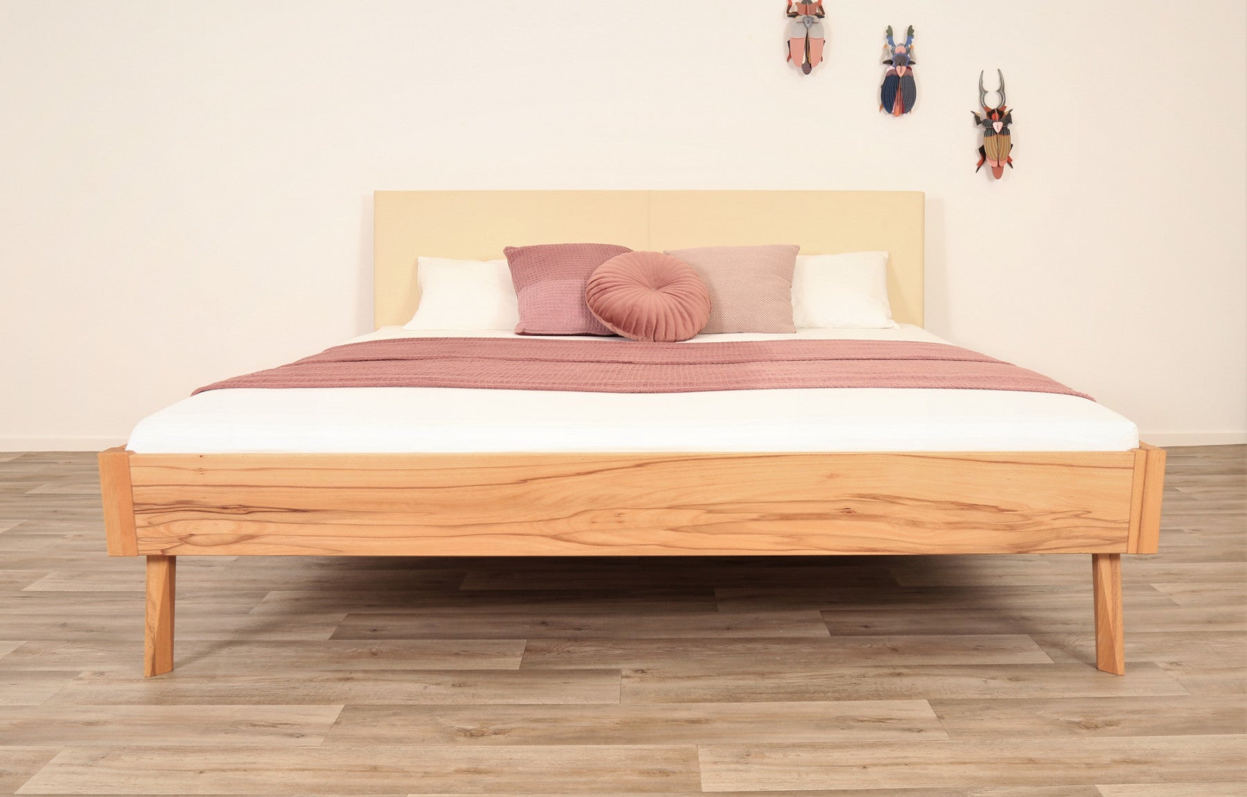 Frontalansicht von Bett Tuxa Premium mit filigranen Füßen und Rinderlederlehne in Elfenbein