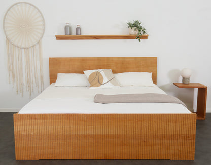 Frontalansicht von Bett Aikana in Buche mit Rückwand und Front mit gefrästem Streifen-Design 